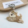 Detail of cute Shiba Inu keychain with marbled resin texture and silver metal clip - Brown Dog