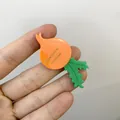 Funny radish-shaped cellulose acetate hair clip with vibrant orange and green colors - Carrot Style