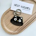 Detail of creative black cat keychain comb with polished finish and metal lobster clasp - Big Eye Black Cat