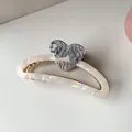 Detail of shell texture claw clip with marble heart and golden spring mechanism - Gray