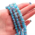 Sky blue faceted glass wheel beads with purple rose floral patterns and gold sand detail - Lake Blue
