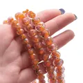 Faceted glass wheel beads in orange with inner floral rose patterns for DIY jewelry making - Orange