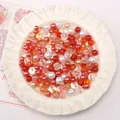 Mix of red and white DIY glass pearl beads for handmade jewelry making in a ceramic bowl - 30g Pack (Approx 2-10mm) / Orange Series