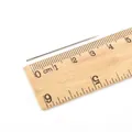 Single 3.2cm large eye steel sewing needle shown on a wooden ruler for size reference - 0.7*40mm