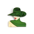 Detailed macro view of a vintage acrylic brooch featuring a lady portrait with green hat - Green