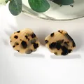Detailed macro view of scallop shell acetate earrings with vintage tortoiseshell pattern - Beige Black Spotted Scallop (EH00101)
