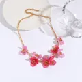 Elegant gold chain necklace featuring vibrant pink resin flowers with a pearlescent finish - Pink Purple