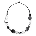 Macro shot of black and white acrylic geometric beads and marble textures on a sweater chain - Black Marbled