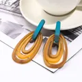 Artistic acrylic geometric earrings featuring teal, amber, and ginger oval rings - Multilayer Nested (EH00146) / Dark Blue-Green And Mustard Yellow
