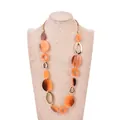 Long geometric sweater necklace featuring amber resin rings and gold metal accents - Orange Marbled