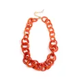 Detailed view of chunky orange acrylic link necklace with adjustable gold metal chain clasp - Orange