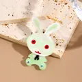 Cartoon acrylic rabbit brooch with green glasses and faux gem accents on stone base - Green White Red