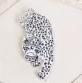 Silver leopard brooch with black spots and crescent moon symbol on beige stone base - White Water Pattern