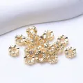 Golden flower relief spacer beads for DIY jewelry making on white textured background - Outer Diameter 6mm / 14K Gold Plated
