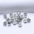 Close-up of polished 5mm ball earring backs with secure silicone core inserts - Flying Saucer Style (Q153) / Platinum Plated