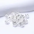 Detailed view of flower-shaped silver spacer beads with relief spiral textures for DIY jewelry - Outer Diameter 6mm / Silver (Color Retention)