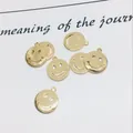 Flat lay of small golden smiling face pendants for DIY jewelry making accessories - 8mm / Gold