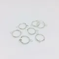 Detailed view of six silver spring clip earrings with small loops for jewelry making - 13mm / Silver