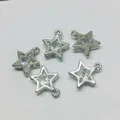 Detailed view of five silver star charms with clear zircon inlays on white background - Five-pointed Star / Silver