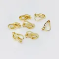 Seven pieces of gold-plated copper triangle clip-on earring converters on white surface - No Loop / Light gold