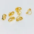 Detailed macro view of seven polished gold triangular clip-on earring converters for DIY jewelry - No Loop / Gold