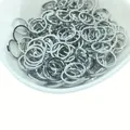 Bulk silver circular metal jump rings for DIY jewelry in a white ceramic bowl - 15mm / Silver