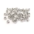 Macro detail of silver plated round metal spacer beads with spiral textured pattern for DIY - 3mm / White Gold