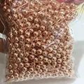 Macro shot of bulk rose gold plated ball head pins in a transparent packaging bag - 3mm Style (D50) / Genuine Rose Gold Color