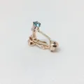 Clip de oreja ajustable en oro rosa con una brillante piedra de circón azul redonda - Oro Rosa Aguamarina Clara