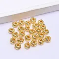 Close-up of 14k gold plated twisted hollow round spacer bead for DIY jewelry making - 18K Gold Plated