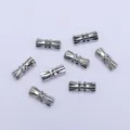 Macro detail of seven silver screw clasps for DIY jewelry making and bracelet connectors - Chrome Color