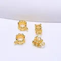 Macro shot of 4 gold hollow flower spacers with crown shape for DIY jewelry making - 3-Way Style / 18K Gold