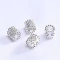 Macro detail of 14k gold-plated clover beads with micro-set zircons on white silk - Four Leaf Clover (Z60) / Silver