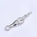 Detailed view of silver hand-shaped jewelry clasp with green gemstone for necklaces - Silver