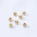 Detailed macro view of 14K gold-filled spacer beads with hollow honeycomb texture and zircon - 18K Gold Filled Color-Preserving (H168)