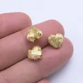 Close-up of heart-shaped 18k gold beads on fingers showing small size and zircon details - 18K Gold Filled (Z135)