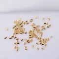 Close-up of 14k gold-filled cylindrical crimp beads for DIY jewelry making and bead crafts - 2.0mm / 18K Gold Plated