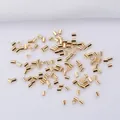 Macro shot of gold-plated crimp beads on white fabric for DIY necklace jewelry making - 2.0mm / 14K Gold Plated