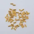 Macro shot of 14K gold filled cylindrical spacer beads with grooved center for DIY jewelry - 18K Gold Plated