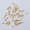 Macro shot of polished gold-plated tubular spacer beads for DIY jewelry making - 14K Gold Plated
