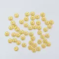 Macro shot of 14K gold-filled hollow round spacer beads with spiral texture for DIY jewelry - 18K Gold Plated