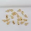Detail of 14K gold plated pinch bails for DIY jewelry making on white fabric - H50 Round 14k Gold Plated