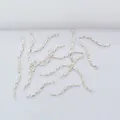 Textured 14k gold plated wave tube spacers for DIY jewelry making on white fabric - Silver
