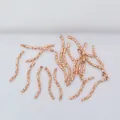 Macro detail of 14k gold filled rose gold curved tube bead with diamond-cut texture - Rose Gold