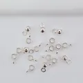 Polished silver metal pendant hooks and spacer beads for DIY jewelry making on white fabric - H50 Round Silver