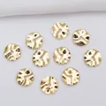 Close-up of 14k gold-filled wavy spacers with hammered metal texture for jewelry making - 4mm (A23) / 14K Gold Plated