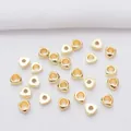 Macro shot of gold triangular spacer beads with polished finish for DIY jewelry crafting - 3mm / 14K Gold Plated