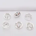 Macro shot of six silver cutout star spacer beads for DIY jewelry making accessories - Silver