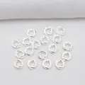 Macro shot of silver 14k gold-filled twisted double rings for DIY jewelry bead making - 4mm Outer Diameter / Silver (Color Retention)