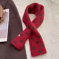 Detail of red knit scarf with dark brown polka dots and minimal brand label on a cozy coat - Polka Dot Style